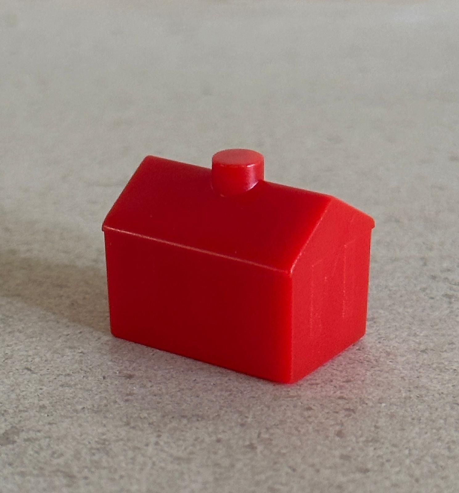 red plastic house, a well-known game piece from the board game monopoly