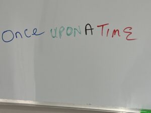whiteboard with the phrase once upon a time written across it