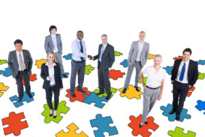group of business people with jigsaw puzzle
