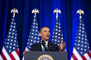 former U.S. President Barack Obama speaking from a podium during an official address