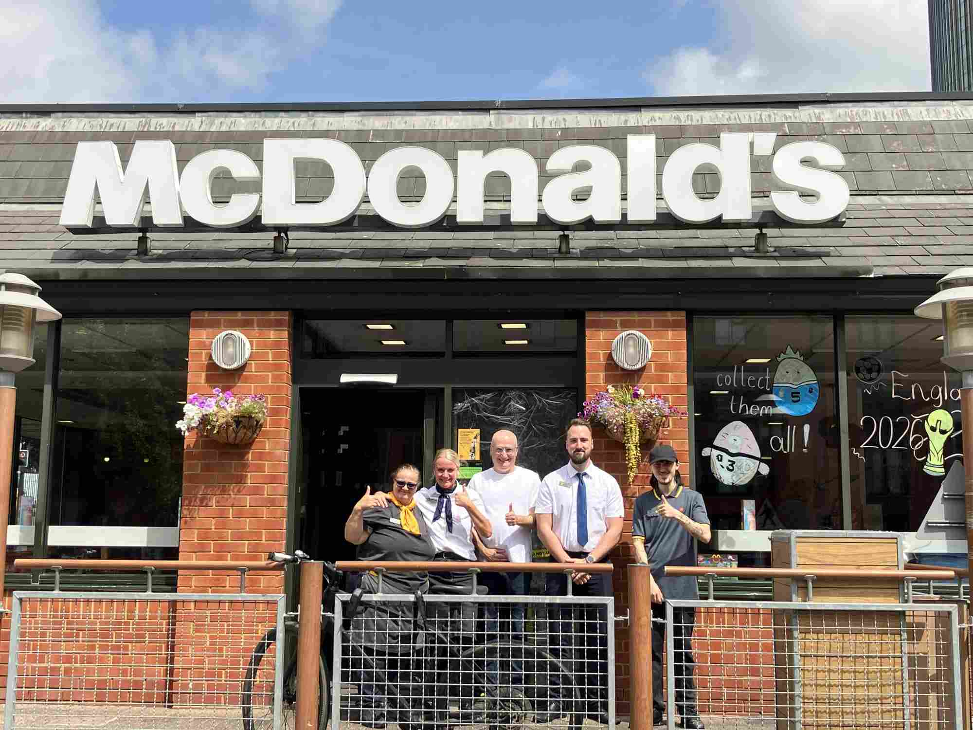 ashley boroda with a group of work colleagues standing outside a mcdonald’s restaurant